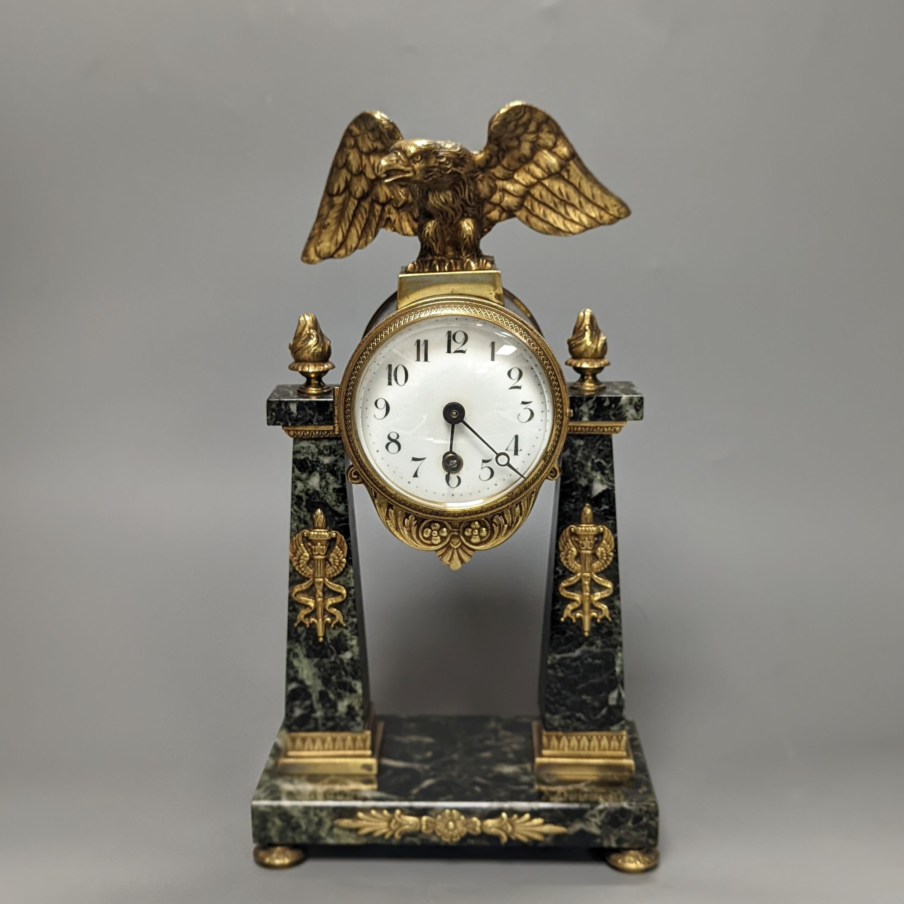 A French Empire style marble and ormolu portico timepiece 32cm